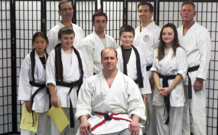 Eight Black Belts promoted Eight Black Belts promoted from the Karate Quest Dojo: Pictured from left to right, standing: Mackenzie Baird, Sean McBride, Aidan OíConnor and Savannah McManus; second row standing: Brad Davidson, Marlon Motta, James McLaughlin and Ed Ackerly; seated is Glenn Finke.