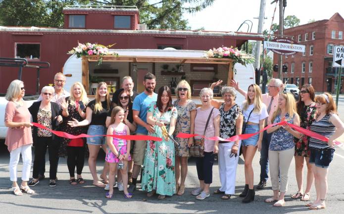 This past July members of the Warwick Valley Chamber of Commerce joined Robert Edelen and Alexa Carrington (center), their relatives and friends, for the grand opening of Parked Prosecco, a bar-on-wheels.
