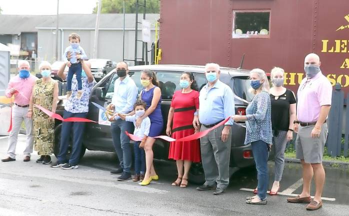 On Thursday, Sept. 3, members of the Warwick Valley Chamber of Commerce joined Dr. Manuel A. Arruffat (center wearing black mask), his family and associates, to celebrate the occasion with a ribbon cutting outside the Chamber “Caboose” on South Street. Photo by Roger Gavan.