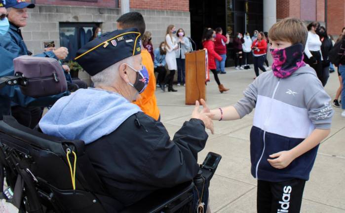 Students rushed up to the honored guests, shaking hands and giving them fist bumps.