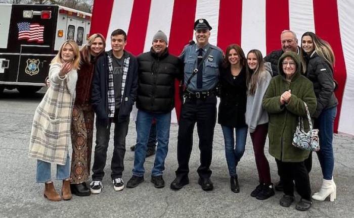 Town of Warwick Police Officer Stephan Helmrich is surrounded by his family on his retirement from the department after 20 years of service. Provided photos.