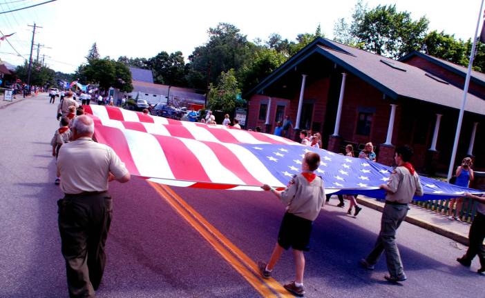 Fun on the Fourth Photos by Ed Bailey The Greenwood Lake Boy Scouts carry a giant flag in celebration of the Fourth.