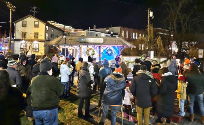 Despite the cold weather, dozens of people gathered to light their candles in a wish for peace on Earth.