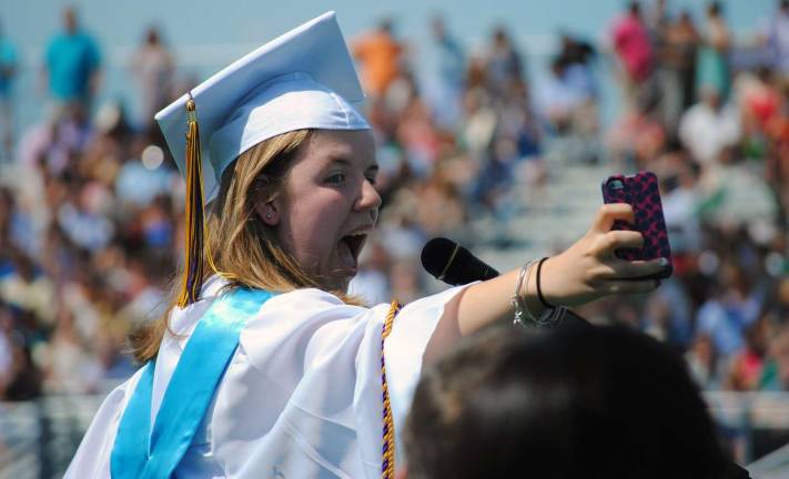 Senior Speaker Clare Finnegan took a selfie at the podium before speaking to her classmates.