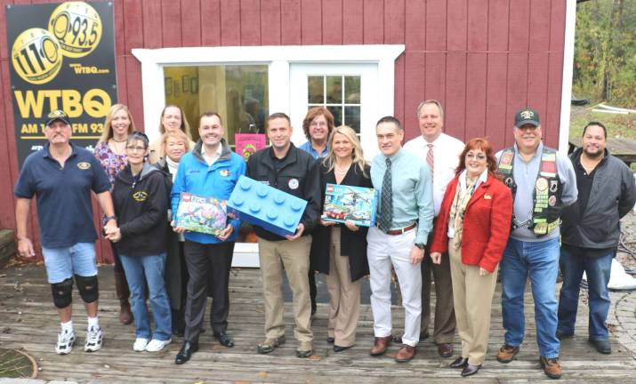 WTBQ launches second annual Toys for Military Tots drive Photo by Roger Gavan Front row from left: Pete and Laura Rollins, representatives from the Disabled American Veterans, WTBQ station manager Taylor Sterling, Phil Royle, LEGOLAND New York's head of community and project relations, Orange County Executive Steven M. Neuhaus, Orange County Partnership Director of Business Retention and Expansion Amanda Dana, Orange County Veterans Service Agency (VSA) director Christian Farrell, Orange County Clerk Annie Rabbitt and Raul Javier of the Nam Knights; rear from left: Kelly Williamson, Airman and Family Readiness Program Manager at Stewart Air National Guard Base, Sara Pastorello, Public Affairs Superintendent of Stewart Air National Guard Base, Nam Knights president Bob Caridi, Frank Truatt, owner of WTBQ and District Attorney David Hoovler.