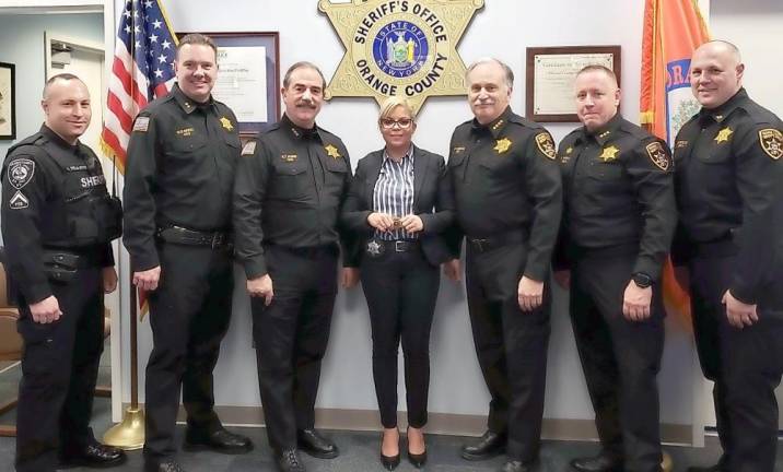 Deputy from the Dominican Republic to be keynote speaker at naturalization ceremony From left: DSPBA President Jeremy Yela, Chief Dennis Barry, Undersheriff Ken Jones, Deputy Carolina Manon, Sheriff Carl E. DuBois, Assistant Undersheriff Tony Weed, and Captain Paul Arteta