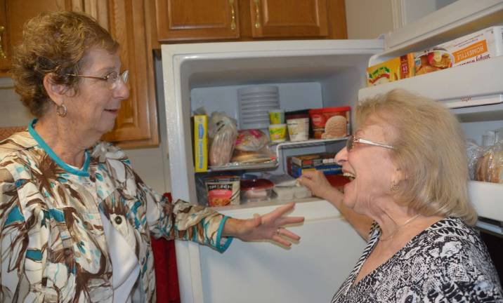 A Close-up of the Friendly Visitor Program in Action Photo provided by Warwick’s Friendly Visitor Program Marcia can now rely on always having her refrigerator stocked with the foods she likes thanks to the volunteer help she gets from Warwick’s Friendly Visitor Program. Marcia, right, is showing volunteer Deanne, left, how well stocked her freezer is because she gets help in getting to the grocery market every week.
