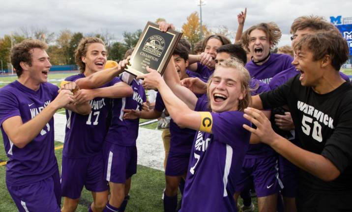 Luke Harrison and his teammates celebrate their 2021 Section IX Champion Wildcats soccer championship victory.