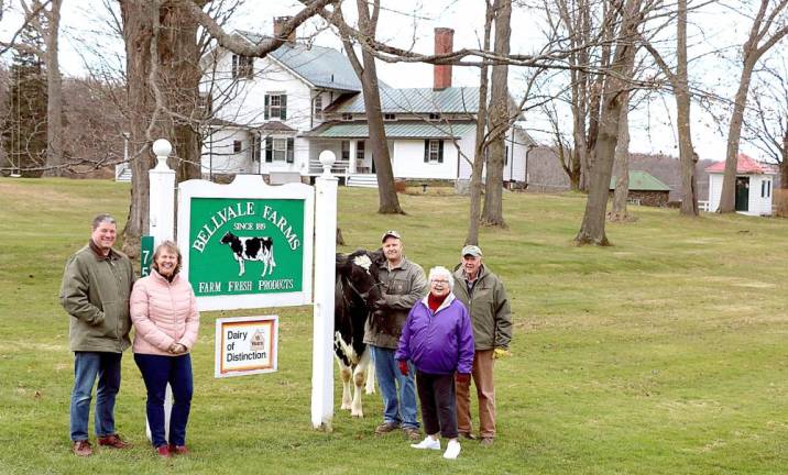 Going forward the Buckbees plan to carry on the centuries old family tradition of dairy farming on their picturesque farm. From left, Tim and Amy Noteboom, “Kapy” the cow, Skip Buckbee and his parents Judy and Al Buckbee. Photo by Roger Gavan.