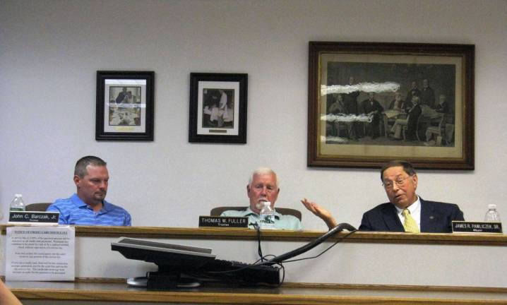 Florida will fight to get cricket frog off endangered list From left: Trustees John Barczak and Thomas Fuller and Mayor Jim Pawliczek at the Aug. 10 village board meeting (Photo by Ginny Privitar)