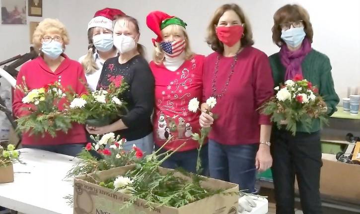 Warwick. Garden therapy team makes holiday flower arrangements for Mount Alverno residents. From left, Ellie Nye, Janice Ashe, Ginny Adams, Mary Pohlman, Laurie Unick and Mary Berrigan.