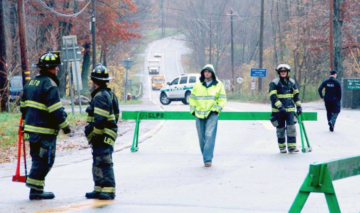 In Sandy’s wake Photo by Ed Bailey Greenwood Lake firefighters guard a gas leak on Route 17A outside of the village on road to Warwick until repairs could be made.