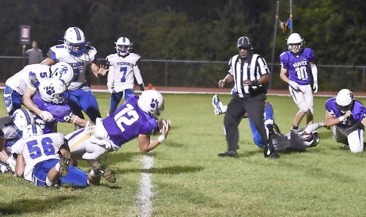 Quarterback Nick DiMarco (12) scores the Wildcats’ first touchdown of the season as Warwick defeats Valley Central 25–20 in front of nearly 3,000 fans at Warwick Valley High School last Friday, Sept. 3. Photo by Al Konikowski.