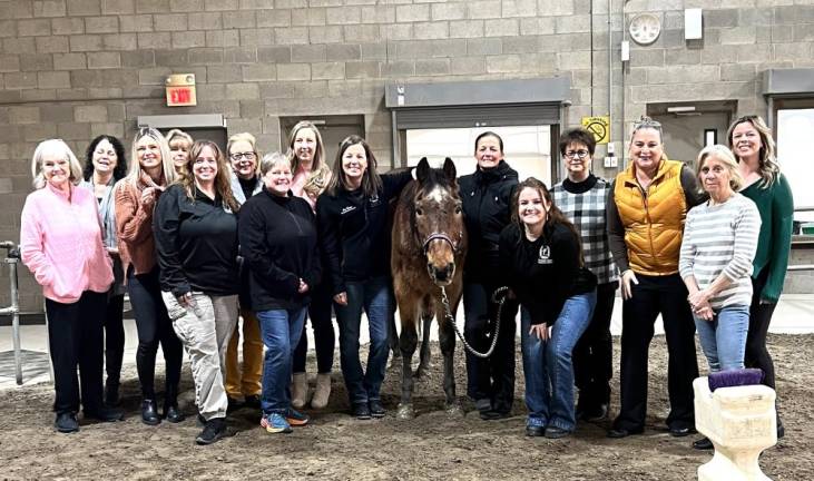 Members of The Golden Gala Committee (L-R): Barb Seeler, AnnMarie Vogel, Erin Corr, Joy Hansen, Vicki Wolf, Sally Woglom, Lori Scaffidi, Bonnie Woglom, Susan Ferro, Brownie the horse, Pamela Loughran, Nicole Ferro, Terry Reilly, Joyce Perron, Theresa Mandracchia, and Roisin Ponkshe. (Not pictured: Al Ridella, Craig Wadeson, Jeanine Wadeson, James Mezzetti, Laura Barca, Leo Kaytes, Marie Malocsay, Mark Malocsay and Terry Gavan)