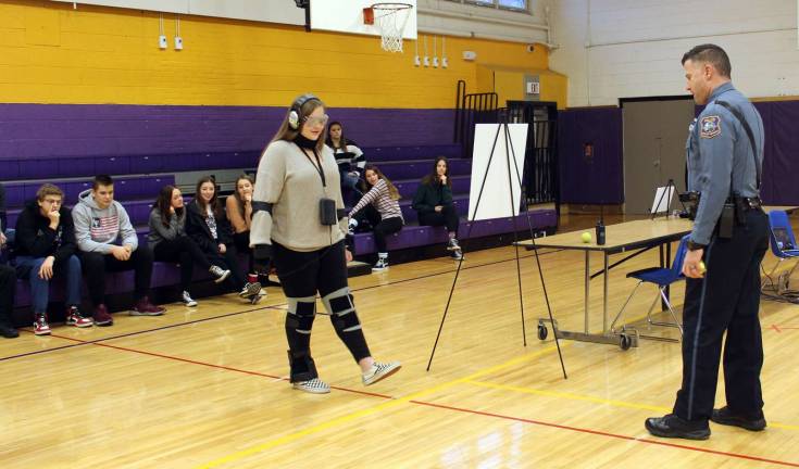 Ford’s innovative suits aim to put the brakes on impaired driving Officer Michael Kearns instructs a student wearing Ford's Drugged Driving Suit.