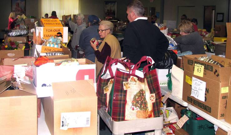 Warwick Ecumenical Council to distribute Thanksgiving Day Food Baskets Nov. 26 Volunteers used shopping baskets to rush final food donations into the building where they were inventoried, stacked on shelves and repackaged for delivery to needy families.