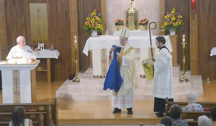 Parishioner Mickey Peppers presented the cardinal with a hooded sweatshirt inscribed with his name and Holy Rosary Church, Greenwood Lake, NY.