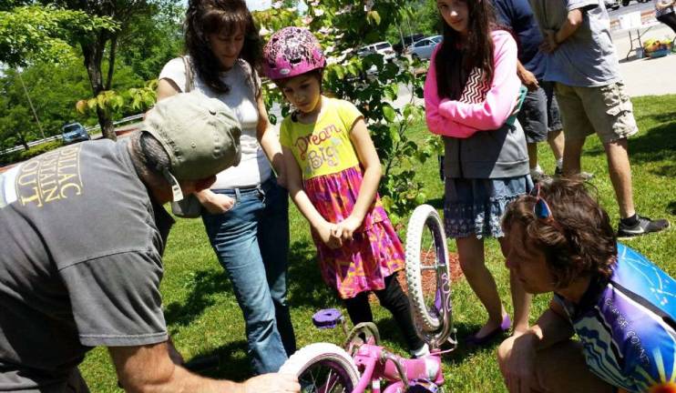 Orange County Bicycle Club helps make Florida Bicycle Rodeo a success This young bicyclist gets a lesson about the importance of tire pressure safety at the rodeo.