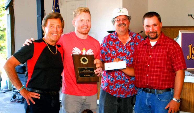 How sweet it is Orchestra leader Jimmy Sturr, left, Michael Golabek of Chicago, Ill., holding his award for winning the eight annual Pine Island ChamberþÄôs onion-eating contest, which was presented by Chamber Director Russell Kowal while Vegetable Growers President Paul Ruskiewicz awards the $100 prize check.