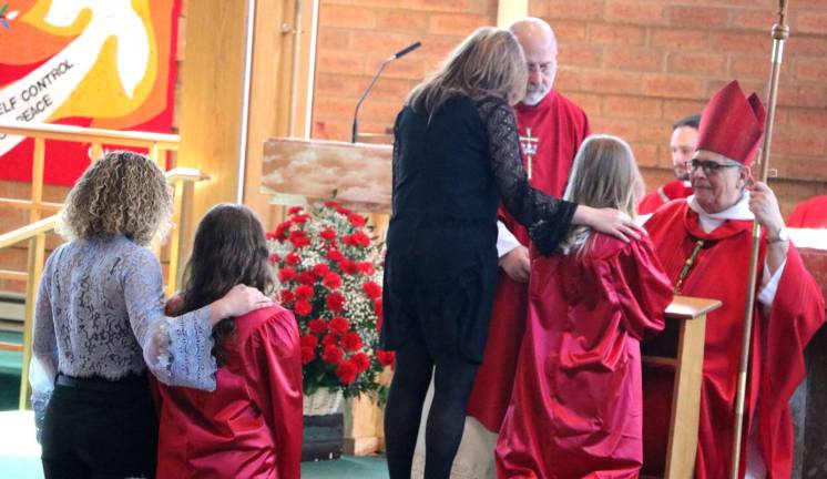 'Confirmation is a sacrament of action' Each candidate, accompanied by his or her sponsor, came forward to be anointed and confirmed one by one by the bishop.