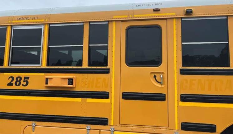 School bus photo safety expands Cameras installed on side of bus near the emergency door.