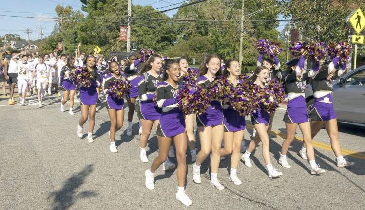 Following the Spirt Trophy game victory at Goshen, Warwick cheerleaders and football players returned home and paraded down Main Street, escorted by Warwick police and firefighters. Photo by Tom Bushey/WVSD.