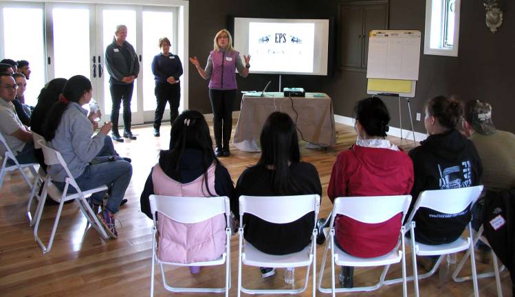 Photo by Roger Gavan The session at Raven Hill Farms began in a newly constructed conference room with an overview of the program, a review of horse dynamics, and an emphasis on learning in a non-judgmental, open ended and fun manner. Facilitators included Director of Development Deirdre Hamling (speaking center), owner and operator of Raven Hill Farms, equine specialist Susan Stegmeyer and licensed clinical social worker Bonnie Malajian.