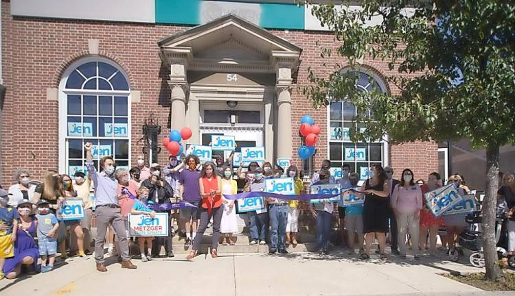 State Sen. Jen Metzger (D-42) and her campaign team officially opened her new Goshen campaign headquarters at the former Bank of America building on Main Street with a ceremonial ribbon-cutting last Friday, Sept. 4. Metzger gave a brief speech towards her re-election bid and then she and her team also handed out lawn signs to those in attendance. Metzger, a Democrat, seeks re-election for a second term. She is challenged by Republican Michael Martucci. The 42nd State Senate District includes cities, towns and villages in Delaware, Orange, Sullivan and Ulster counties. In Orange, those municipalities include ten towns, including of Goshen, Tuxedo and Warwick, and seven villages, including Florida, Goshen, Greenwood Lake, Tuxedo Park and Warwick. Photo by Henry Smith/American Image Press.