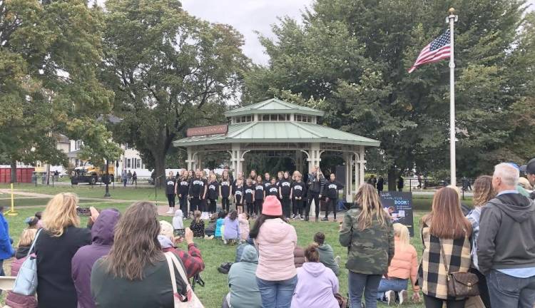 Warwick’s Center for Performing Arts performers singing before a crowd.