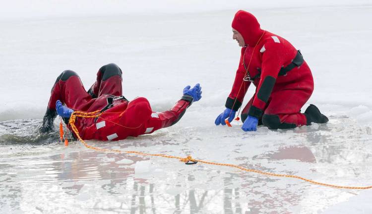 Preparing for when hell freezes over In addition to learning how to rescue victims who have fallen through the ice firefighters must also train how to use hand held spikes to pull themslves far enough up on the ice where they can then roll over while wearing the buoyant wet suits as seen here with Matthew Sapson (left) assisted by Scott Hansen.