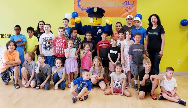 Next generation of engineers descend on Robotics4U open house Software engineer Monali Monali Verma (right) and Legoland New York's Officer Parks (center back) with students and participants of the recent open house (Photo provided)