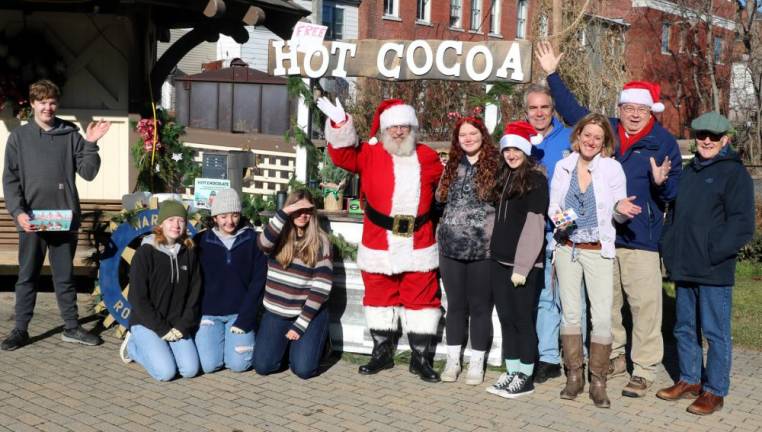 On Sunday, Dec. 12, during the celebration of Home for the Holidays, members of the Warwick Valley Rotary Club and volunteer students from Warwick Valley High School were on hand at Railroad Green to serve free hot cocoa to visitors. The team is scheduled to return this Sunday, Dec. 19, and shoppers are invited to stop by from 11 a.m. to 5 p.m. for a free cup of hot cocoa. Photo by Roger Gavan.