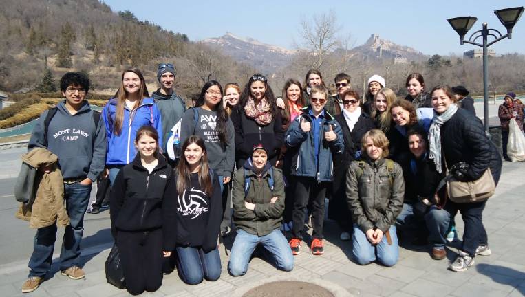 A journey of a thousand miles Behind the 18 students from Orange County stands the Great Wall of China.