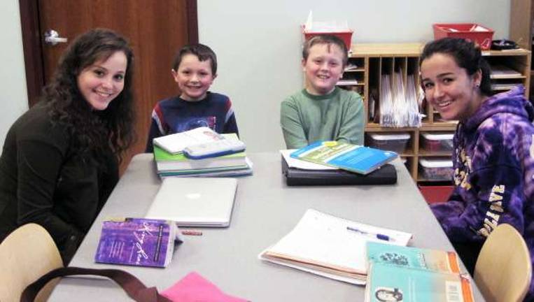 Homework help available at the library Mackenzie Martin and Caitlin Loyka help brothers Gavin and Griffen Zimmerli with their homework assignments as part of the "Homework Buddies" program at Albert Wisner Public Library.
