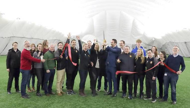 Hudson Sports Complex celebrates official grand opening of the new Dome On Thursday evening, Feb. 6, Town of Warwick Supervisor Michael Sweeton (right), Mayor Michael Newhard (front left) and members of the Warwick Valley Chamber of Commerce joined owners Christian and Raluca Fuchs (center), their staff and management to celebrate the official grand opening of the Hudson Sports Dome.