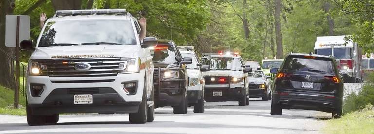 Families gathered on their front lawns waiting for the Memorial Day drive by parade in Pine Island on Monday, May 25. Photo by Robert G. Breese.