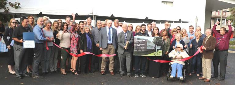 Business community year in review 2017 On Oct. 12, state, county and local officials along with members of the Warwick Valley Chamber of Commerce joined Douglas R. Stage and William Nathans for a ribbon cutting celebrating three anniversaries in the history of the law firm. William Nathans and Douglas Stage (center) cut the ribbon held by Mayor Michael Newhard (left) and Town of Warwick Supervisor Michael Sweeton (right).