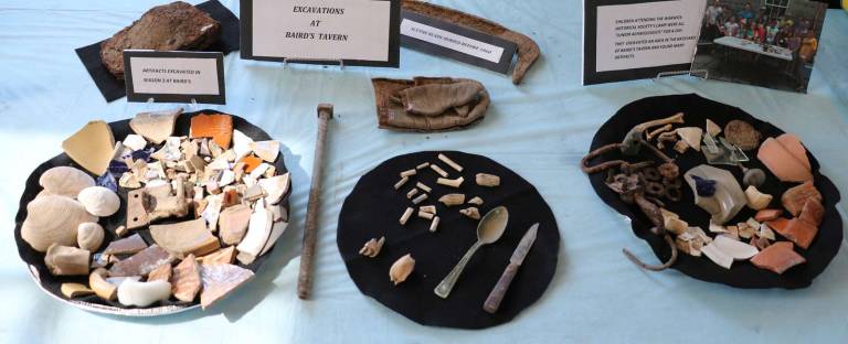 The numerous artifacts on display for the presentation included a 1753 British half-penny, an 1818 US cent and an 1864 Indian Head penny along with beverage and medicine bottles, buttons, pottery and dish shards, glass, clay pipes, doll heads, marbles, nails and animal bones.