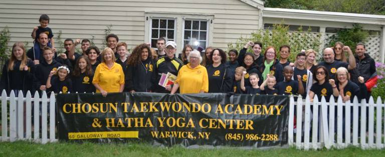Chosun Taekwondo ninth annual Book and Bake Sale held in Lewis Park Provided photo The Chosun Taekwondo Academy Leadership Team, with Town of Warwick Supervisor Michael Sweeton and Lions Club Event Chairwoman Claire Gabelmann (center).