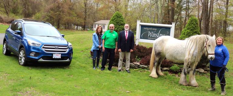 Photo by Roger Gavan The hole-in-one prize, courtesy of Leo Kaytes Ford in Warwick, is a brand new all-wheel drive 2019 Ford Escape SE like the car pictured here.From left, Winslow Executive Director Susan Ferro. Leo Kaytes Ford CEO Leo Kaytes, Hudson Regional Pharmacy CEO Angelo Angerame and Winslow Instructor and Golf Outing Committee member Kim Longo with &quot;The Dance,&quot; one of the gentle therapy horses.