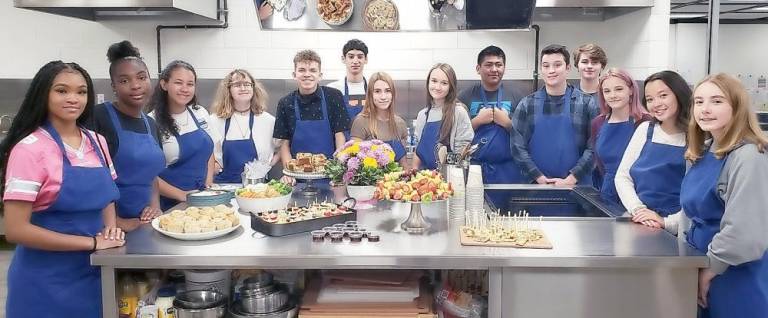 High School culinary arts students show off their freshly prepared breakfast appetizers in the new middle school’s new industrial kitchen.