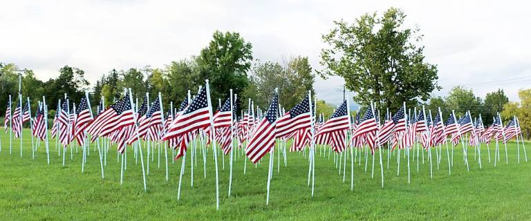 The sea of flags flying with plaques identifying each local hero. File photo by Roger Gavan.