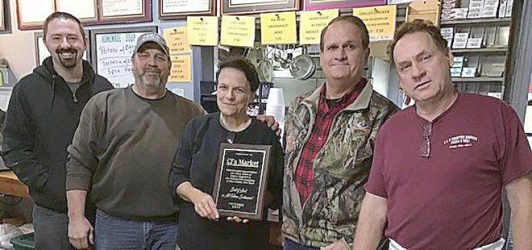 The Pulaski Fire Company in Pine Island presented a plaque of appreciation to Jeanie and John Reiley of CJ’s Market on their retirement. With more than years of a community business, Jeannie and John have been helpful to many local organizations. CJ’s Market will be under new management. From left are Jim Day, Jeannie Reiley's son; Floyd Morgiewicz, president of the Pulaski Fire Company; Jeannie Reiley; David Paffenroth, secretary treasurer of fire company; and John Reiley, owner of CJ’s.