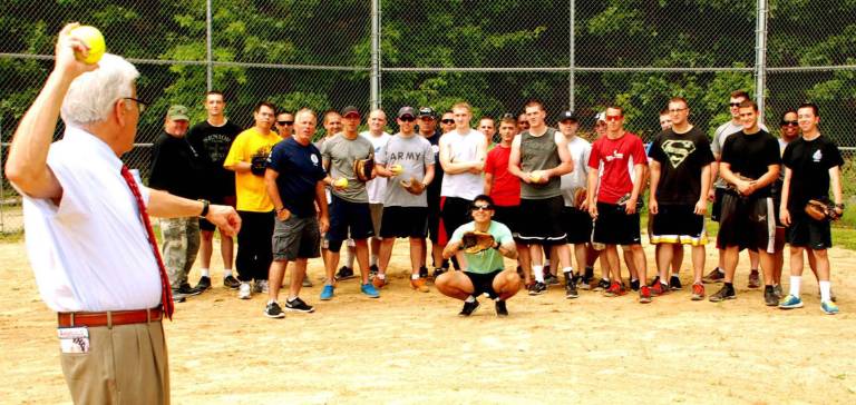 GWL American Legion host barbecue for troops New York State Supreme Court Justice Daniel D. Angiolillo throws out the first pitch for the softball game played by members of the U.S. Armyís Tenth Mountain Division at a barbecue hosted for the solders earlier this month by the Greenwood Lake American Legion.