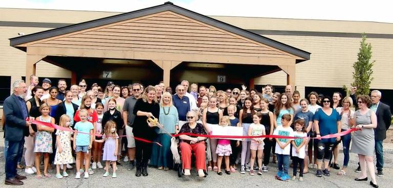 On Thursday, Sept. 16, Mayor Michael Newhard (left) and members of the Warwick Valley Chamber of Commerce, joined founder Melissa Padham-Maass (center), her family, associates, parents and students to celebrate the grand opening of the Warwick Center for the Performing Arts new facility with a ribbon-cutting ceremony. Photo by Roger Gavan.