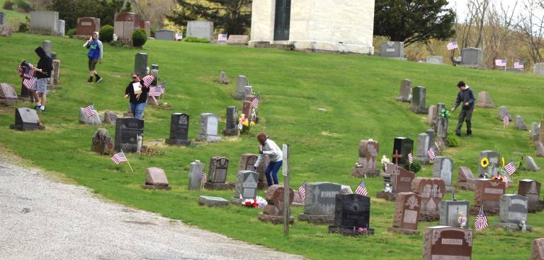 'Someday, you will have to carry on for us' Photos by Roger Gavan On Saturday, April 27, volunteers from Warwick’s American Legion Post 214 along with members of Boy Scout Troop 45 placed flags at the grave sites of local veterans.