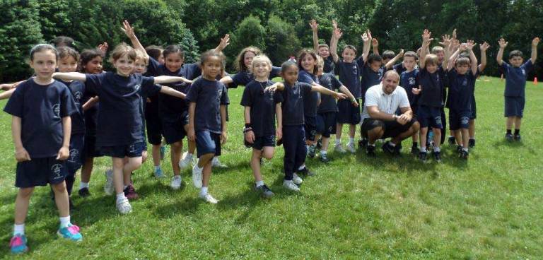 Walk to help Catholic schools and the Food Bank set for June 14 Photo provided First-graders at Sacred Heart School in Monroe learn from their gym teacher Ron Beller about preparing for the Regional Catholic Schools 5K Race/Walk.