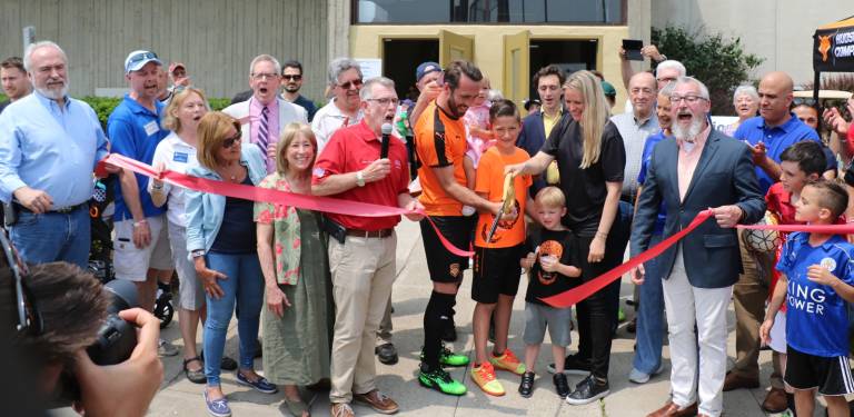 Hudson Sports Complex celebrates official grand opening On Saturday, June 1, local officials including Town of Warwick Supevisor Michael Sweeton (holding microphone) and Mayor Michael Newhard (far right) along with members of the Warwick Valley Chamber of Commerce joined owners Christian and Raluca Fuchs (center), their family, staff and associates to celebrate the official grand opening of the Hudson Sports Complex.
