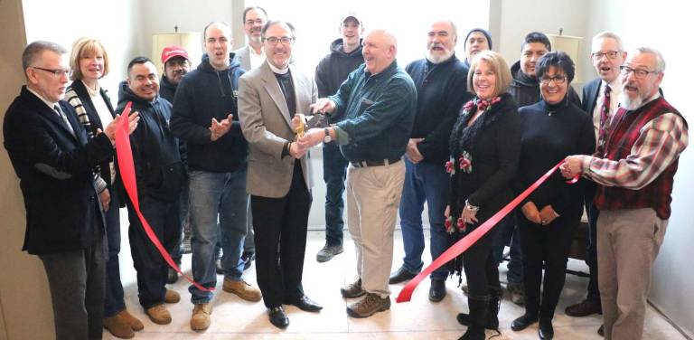 Christ Church celebrates renovation project at ribbon-cutting ceremony Photo by Roger GavanOn Wednesday, Dec. 13, Town of Warwick Supervisor Michael Sweeton (far left), Mayor Michael Newhard (far right) and members of the Warwick Valley Chamber of Commerce joined Rector Rev. Jim Erwin, General Contractor Thom and David Woglom (center) and their staff for a ribbon-cutting ceremony to celebrate completion of the project's first phase.