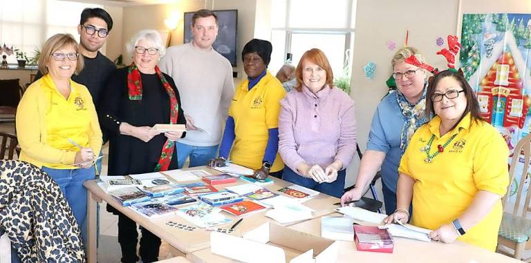 Members of the Warwick Lions Club visited Mt. Alverno Center to help senior residents address and mail Christmas cards.